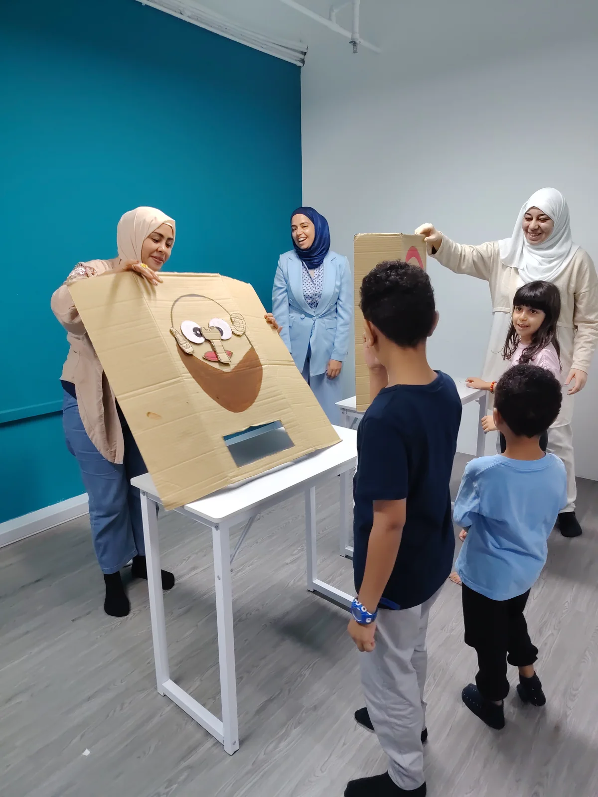 Teachers and learners with cardboard story faces