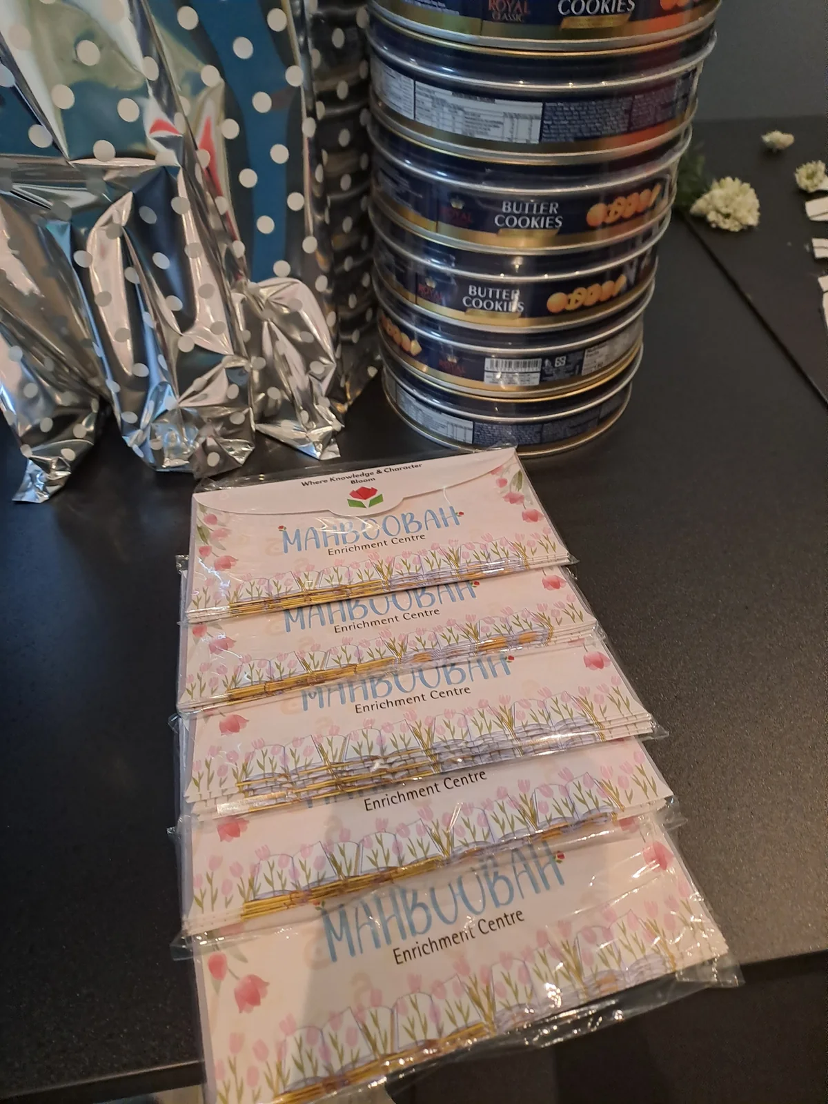 Mahboobah envelopes beside cookie tins
