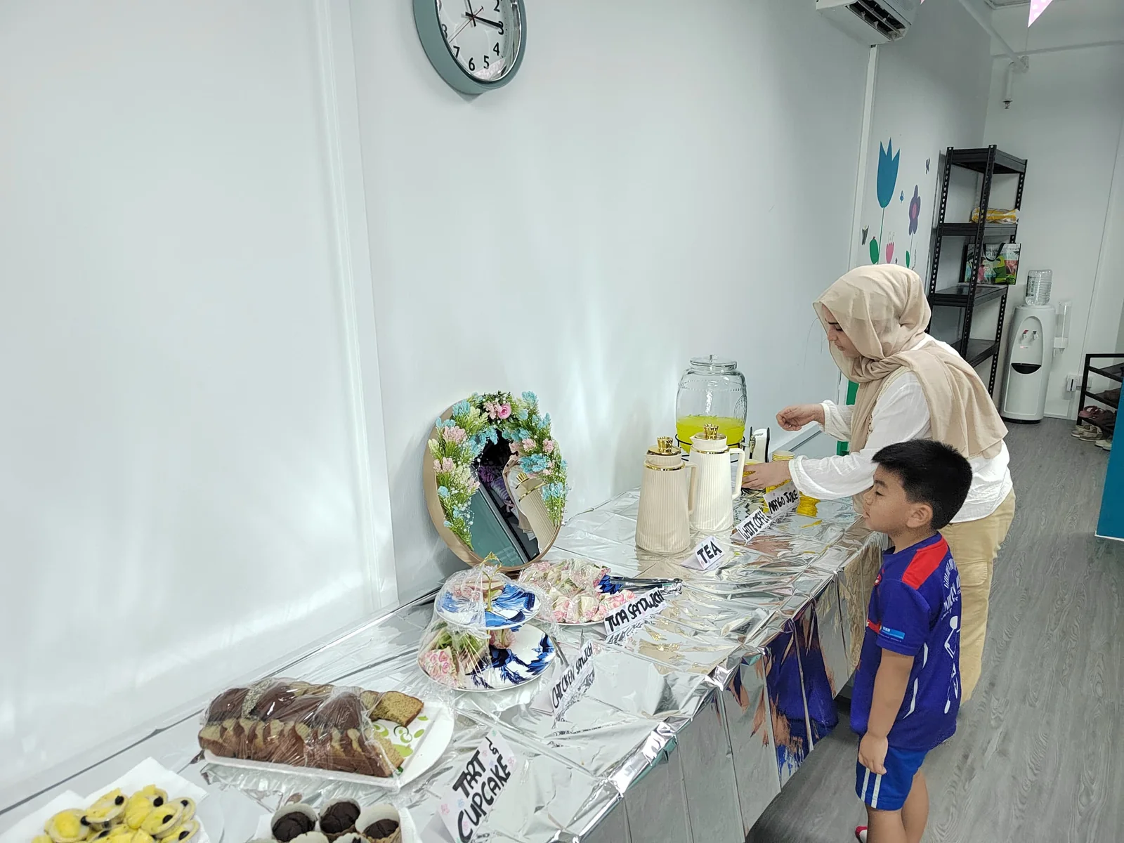 The camp table — sandwiches, tarts, tea, and white coffee