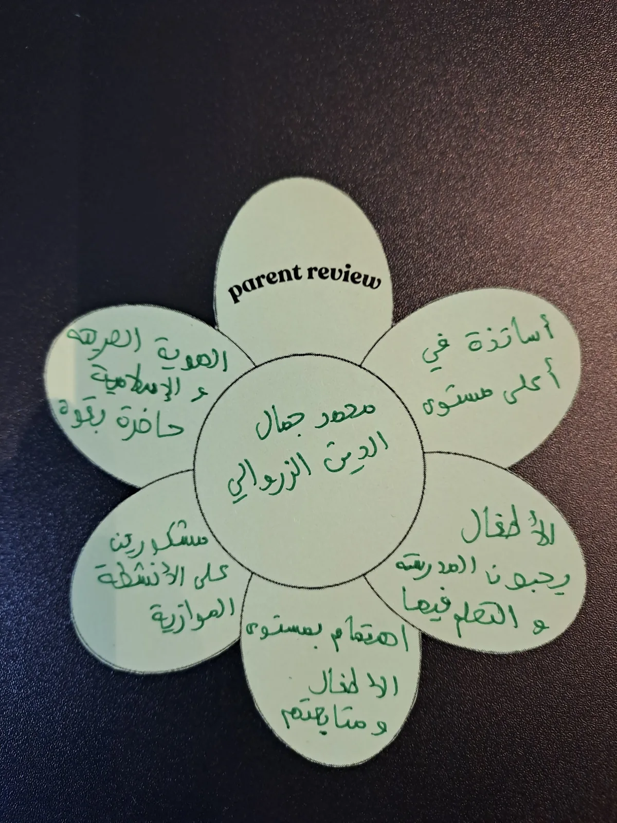 A parent review in Arabic, written on a paper flower